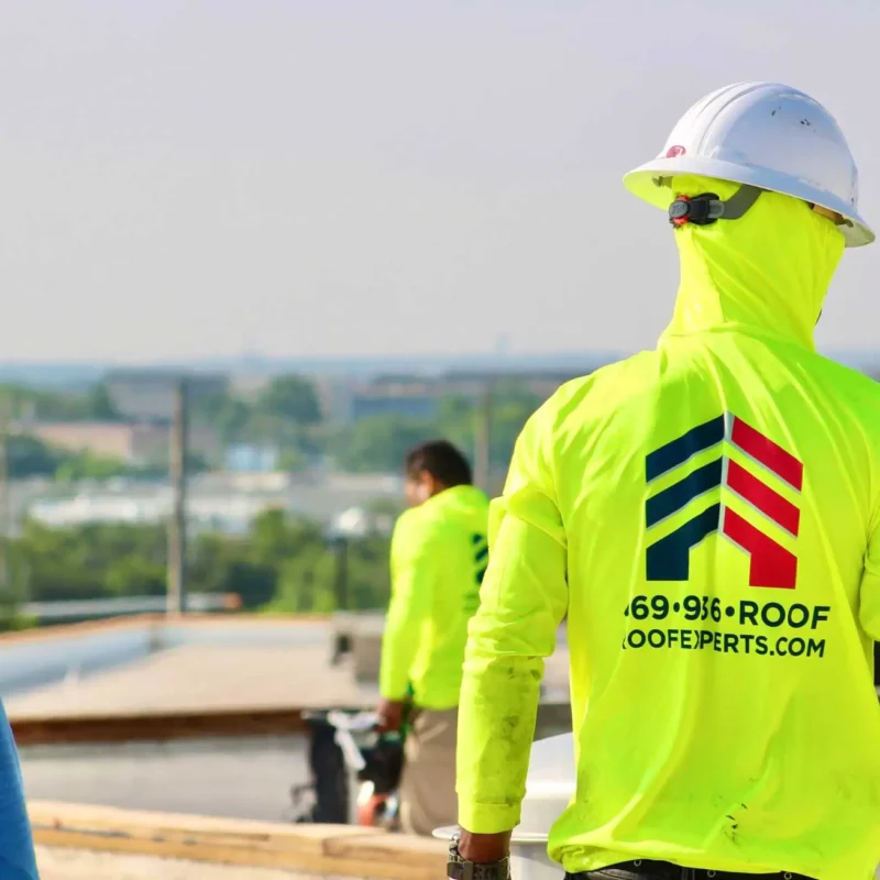 Roof Experts professional at work on commercial TPO roof.