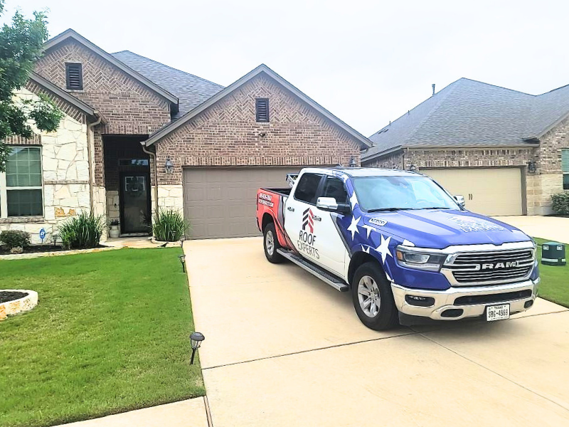 Roof Experts vehicle at client residence for shingle roof repair