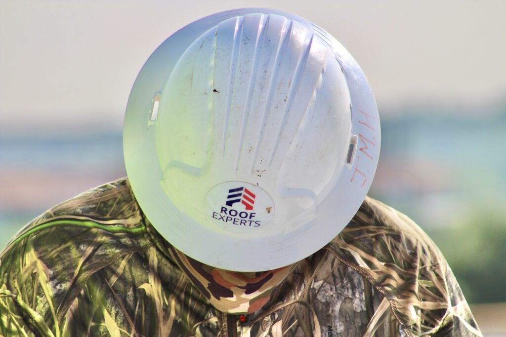 Roof Experts contractor examining work on site in Austin TX