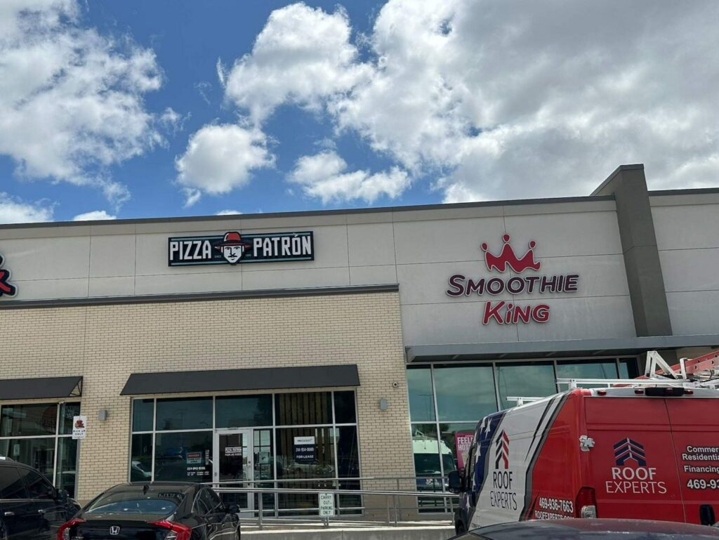 Roof Experts truck at a commercial roofing job at a Dallas, TX retail center