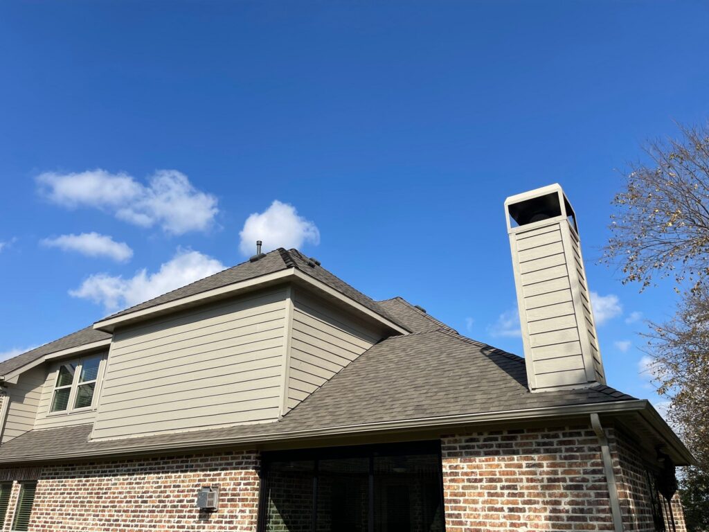 New shingle roof and chimney chase on a home in Grapevine, TX