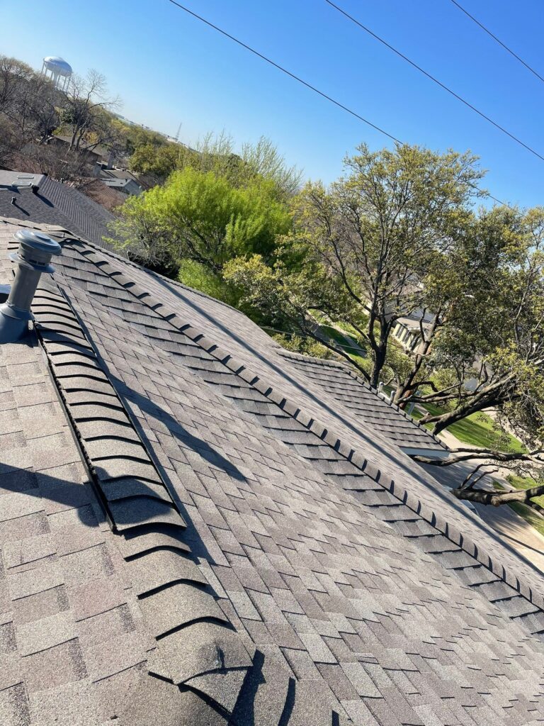 Ridge cap shingles being installed on a residential roof by Roof Experts
